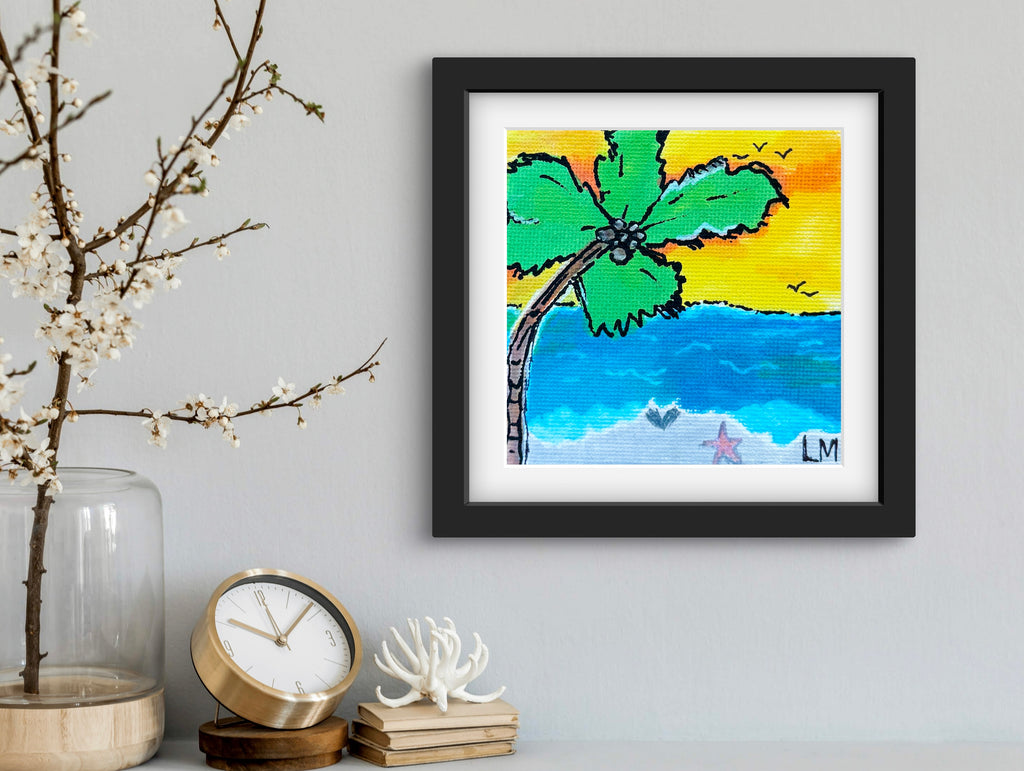 Framed artwork of a palm tree and beach scene on a wall with decorative items below.