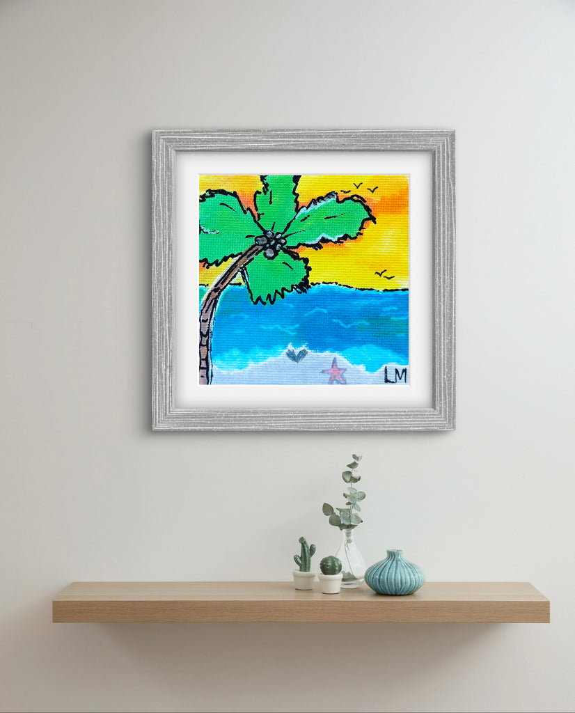 Framed artwork of a palm tree and beach scene on a wall above a shelf with decorative items.