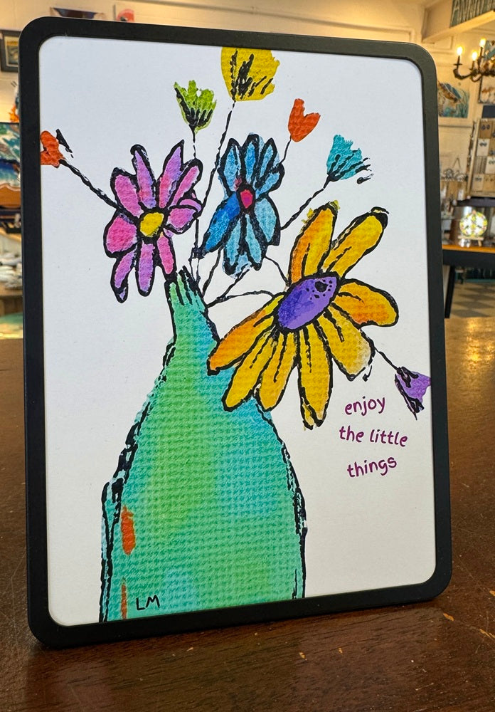 Colorful artwork of flowers in a bottle with 'enjoy the little things' text on a white background.