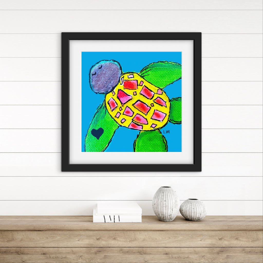 Framed artwork of a colorful turtle on a white wall with wooden floor.