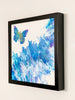 Expansion butterfly painting viewed from the right, showing the depth of its black gallery frame